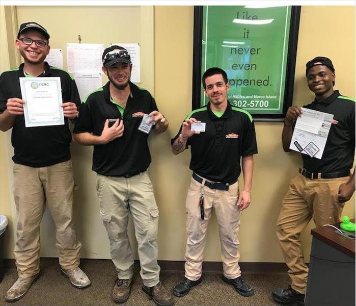 4 SERVPRO employees holding up IICRC water damage restoration certifications